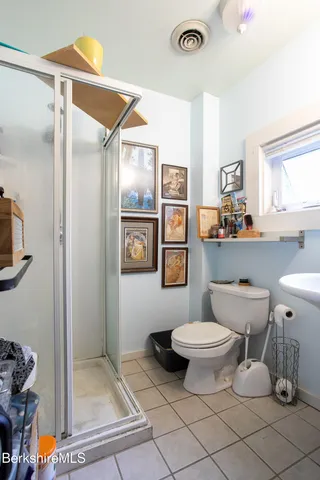 a bathroom with a toilet sink and shower