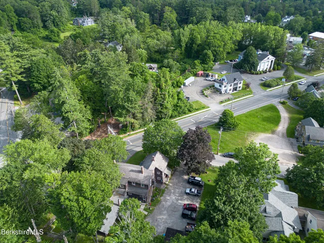 an aerial view of a house with yard swimming pool and outdoor seating