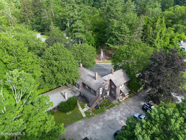 an aerial view of a house with a yard