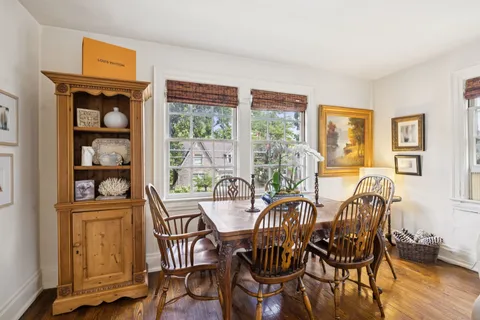 a living room with furniture fireplace and a large window
