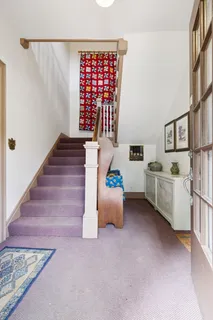 a living room with furniture fireplace and a large window