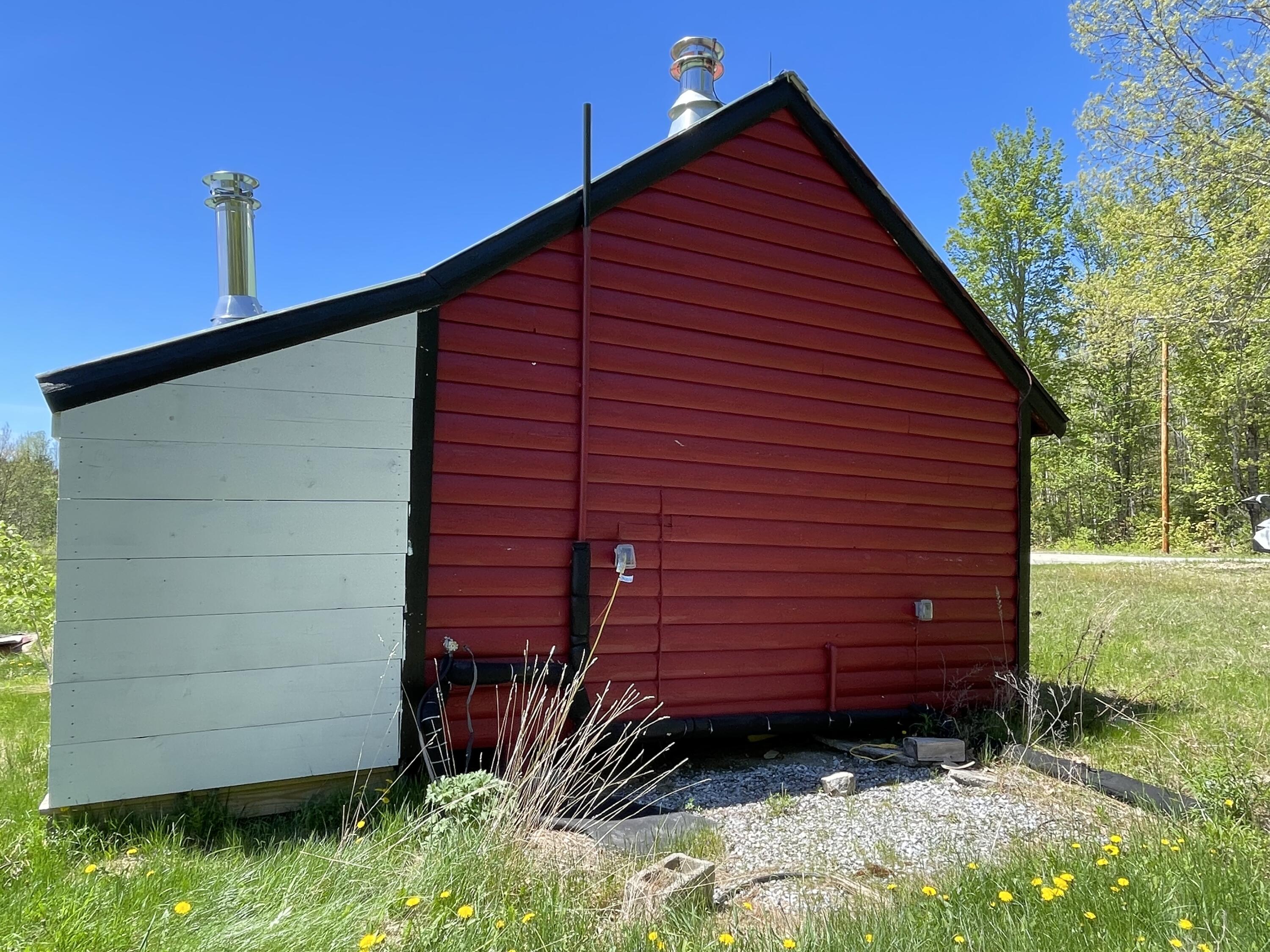 43 Baker Road Burlington, ME 04417 - Photo 12 of 12 Hattabaugh cabin back side exterior