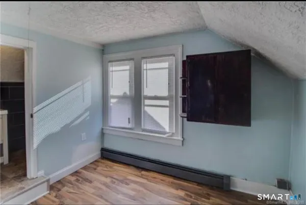 a view of a room with wooden floor