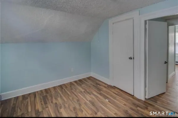 a view of hallway with wooden floor