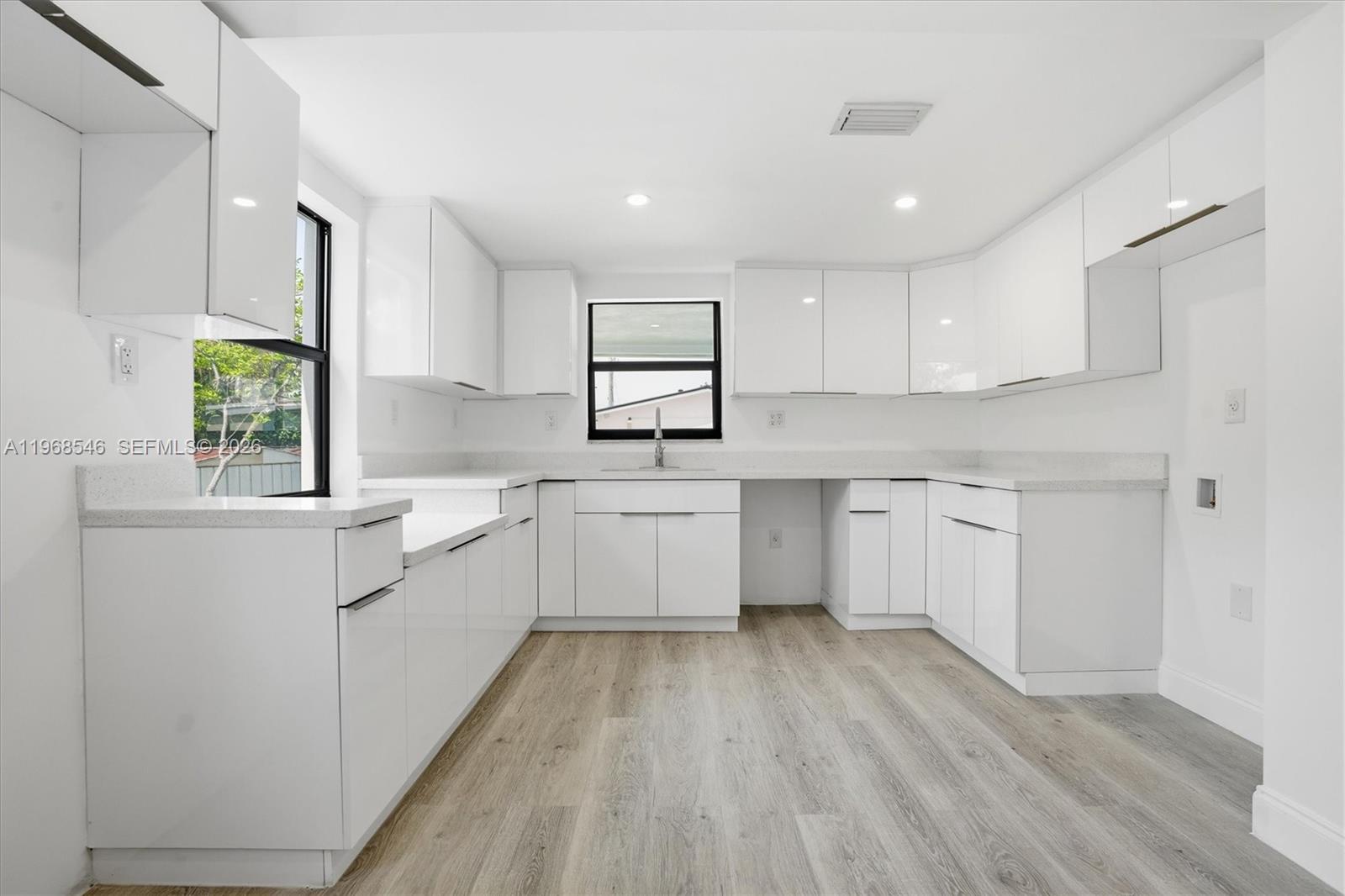 4237 Southwest 7th Street Miami, FL 33134 - Photo 7 of 31 a kitchen with a white wooden cabinets and window