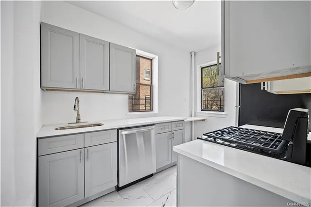 a kitchen with cabinets appliances and a window