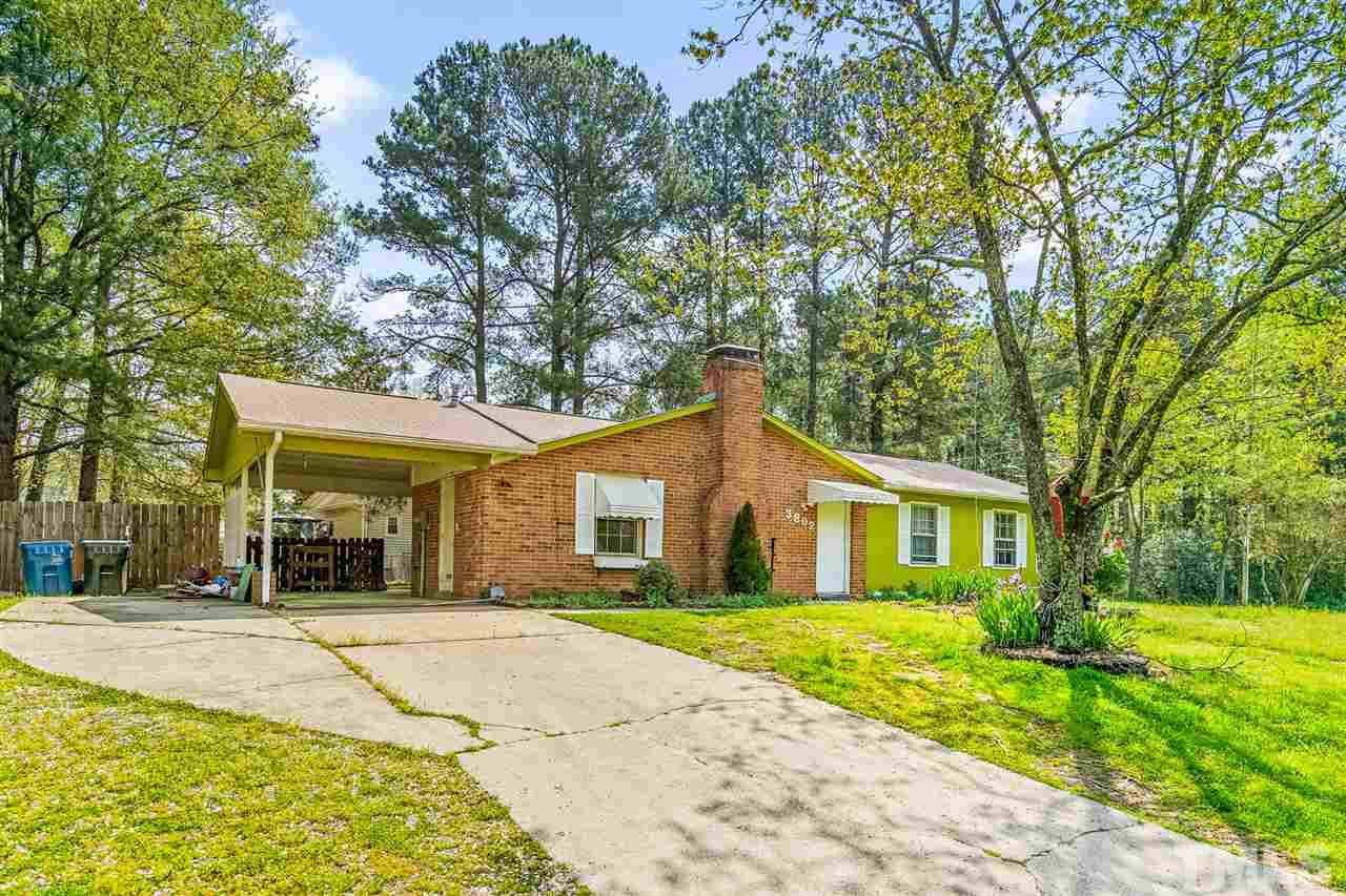 3802 Ruggles Street Durham, NC 27704 - Photo 3 of 20 a front view of a house with a yard and potted plants