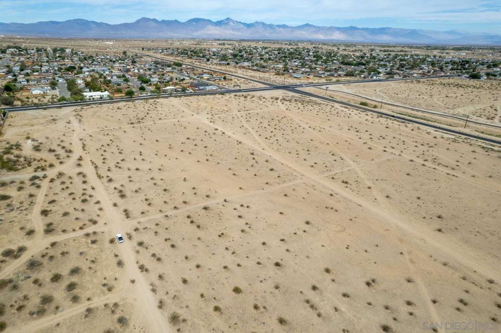 0 Perch Avenue Ridgecrest, CA 93555 - Photo 5 of 40 a view of a dry yard with a large trees