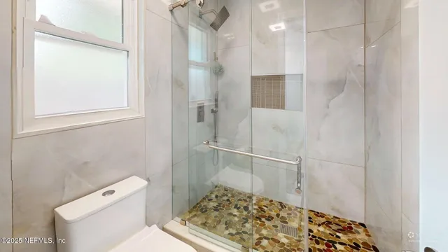 a view of a living room with furniture and flat screen tv