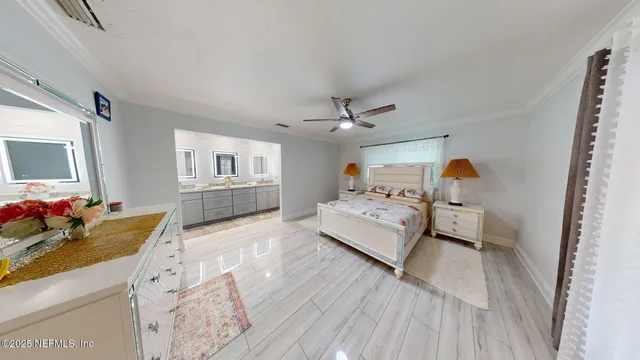 a bedroom with bed and a large mirror