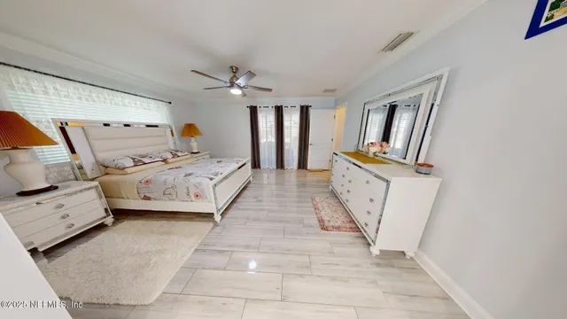 a bedroom with a bed lamp and a window