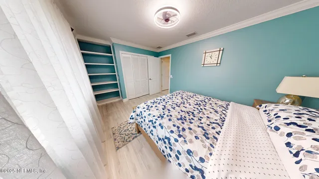 an empty room with windows and chandelier