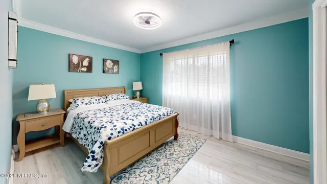 an empty room with chandelier fan and windows