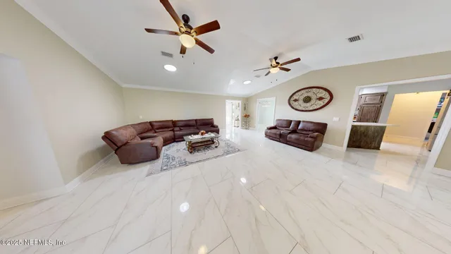 a view of a hallway with windows and chandelier