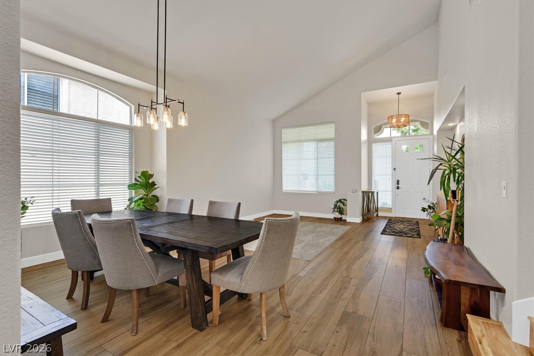 1259 Moon Vision Street Henderson, NV 89052 - Photo 2 of 53 Natural light illuminates the elegant dining area and the welcoming entryway.