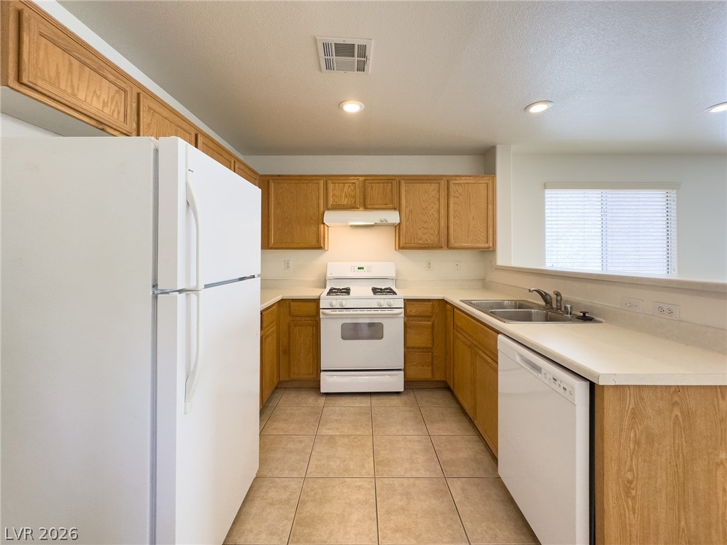 9456 Grandview Spring Avenue Las Vegas, NV 89166 - Photo 14 of 49 Functional kitchen with ample cabinetry and essential appliances awaits your personal touch.