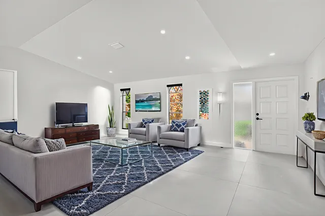 an empty room with a window and a ceiling fan