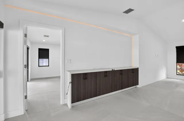 a spacious bathroom with a double vanity sink mirror and bathtub