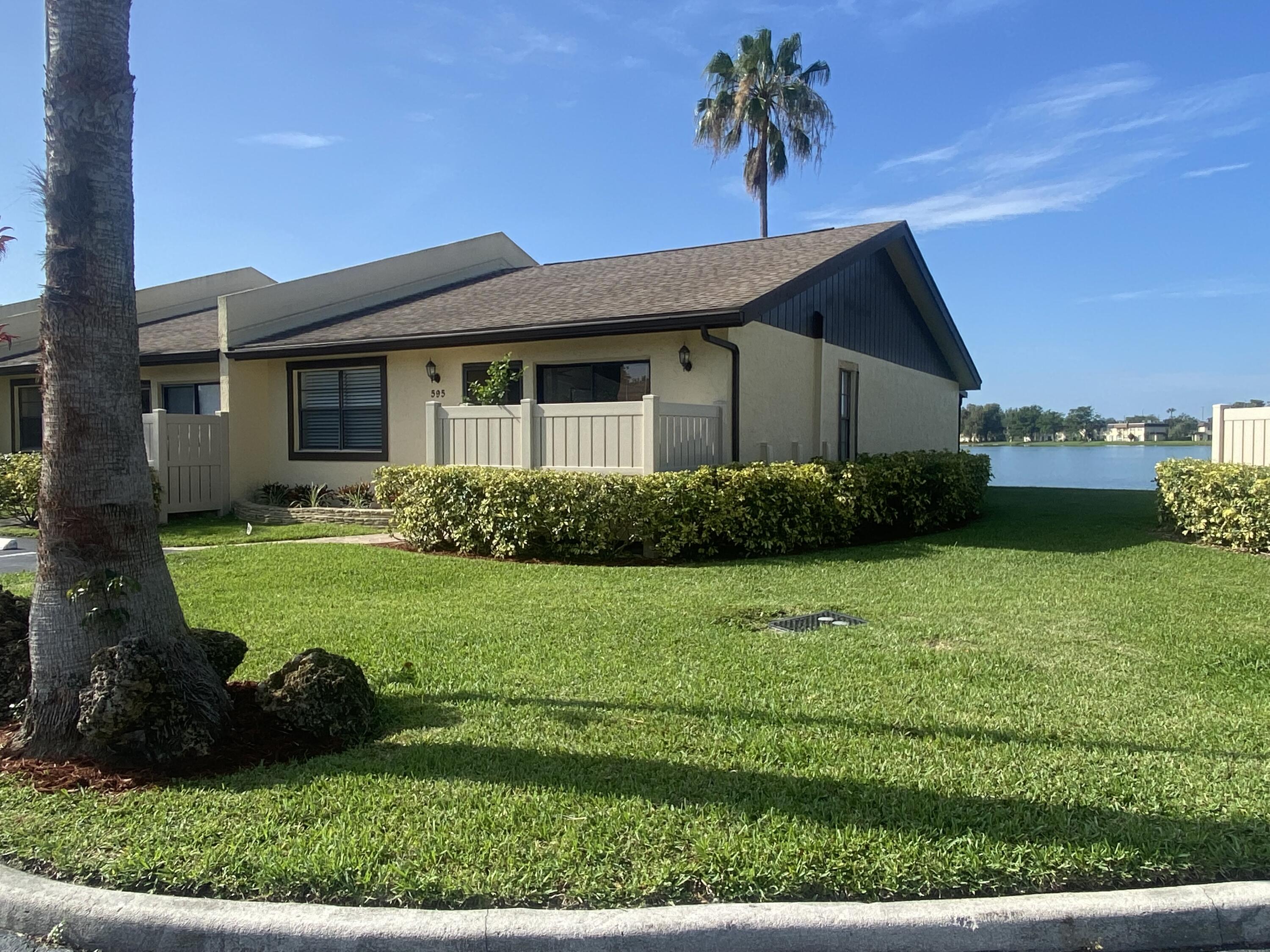 595 Banks Road Margate, FL 33063 - Photo 9 of 35 a front view of a house with garden