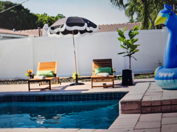 a view of a lobby with a chair and potted plants