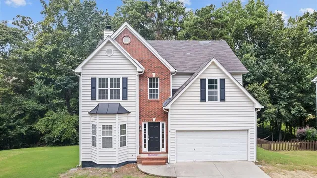 a view of house with a yard