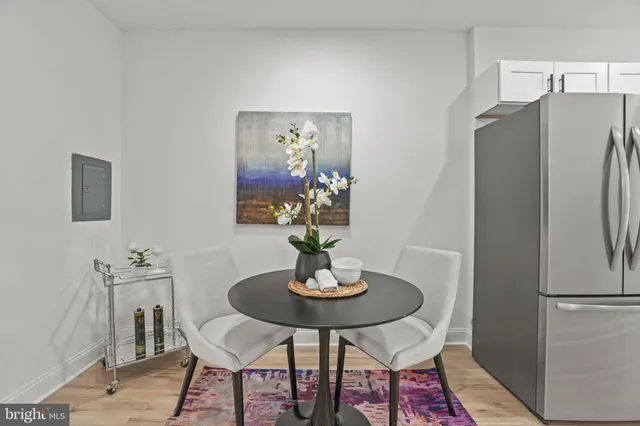 a kitchen with a refrigerator and dining table