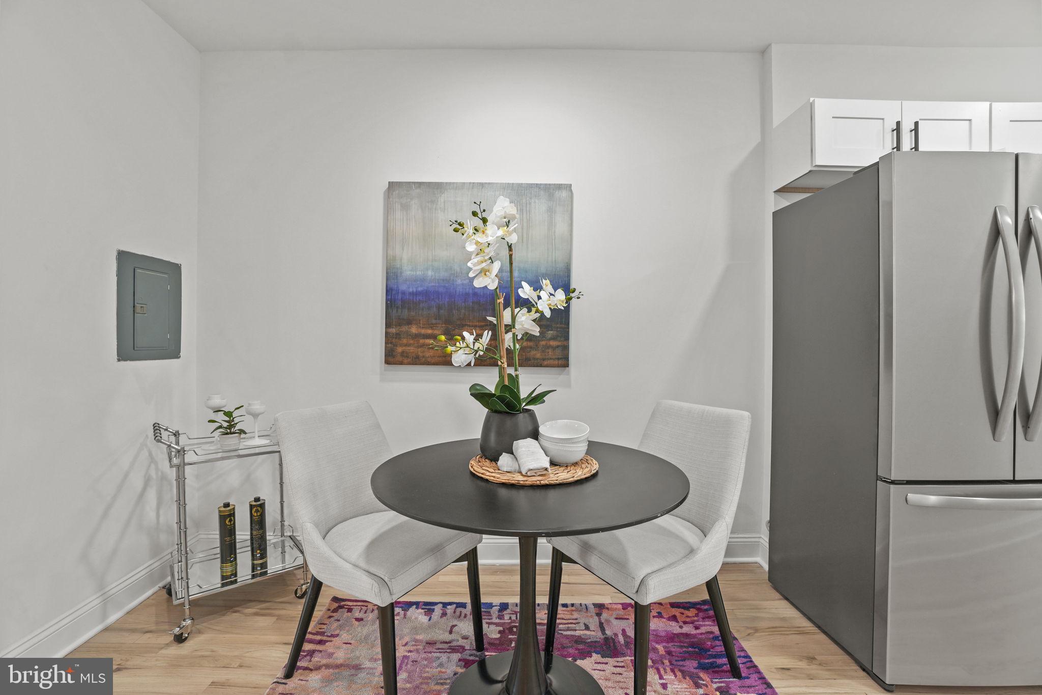 1653 Trinidad Avenue Northeast, Unit 2 Washington, DC 20002 - Photo 2 of 17 a kitchen with a refrigerator and dining table
