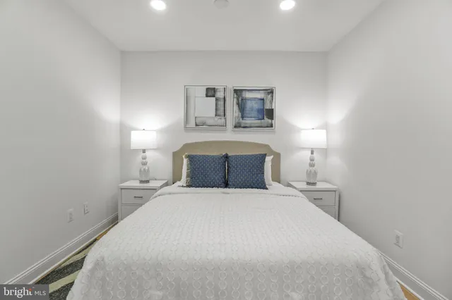 a bedroom with a bed and a night stand