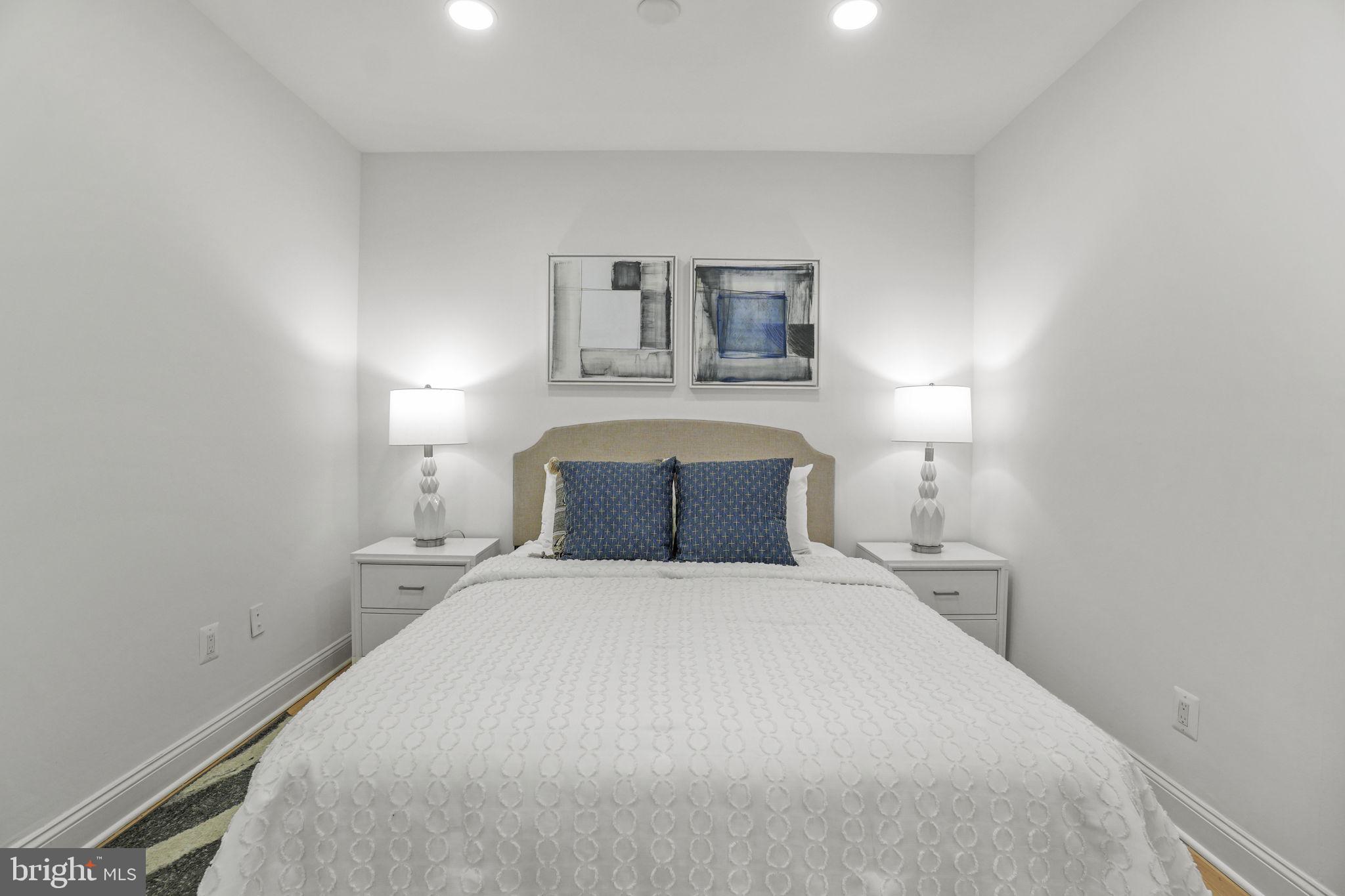 1653 Trinidad Avenue Northeast, Unit 2 Washington, DC 20002 - Photo 5 of 17 a bedroom with a bed and a night stand