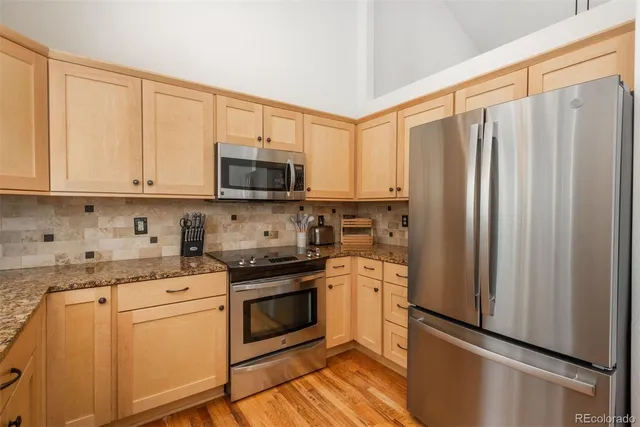 a kitchen with stainless steel appliances a refrigerator stove and sink