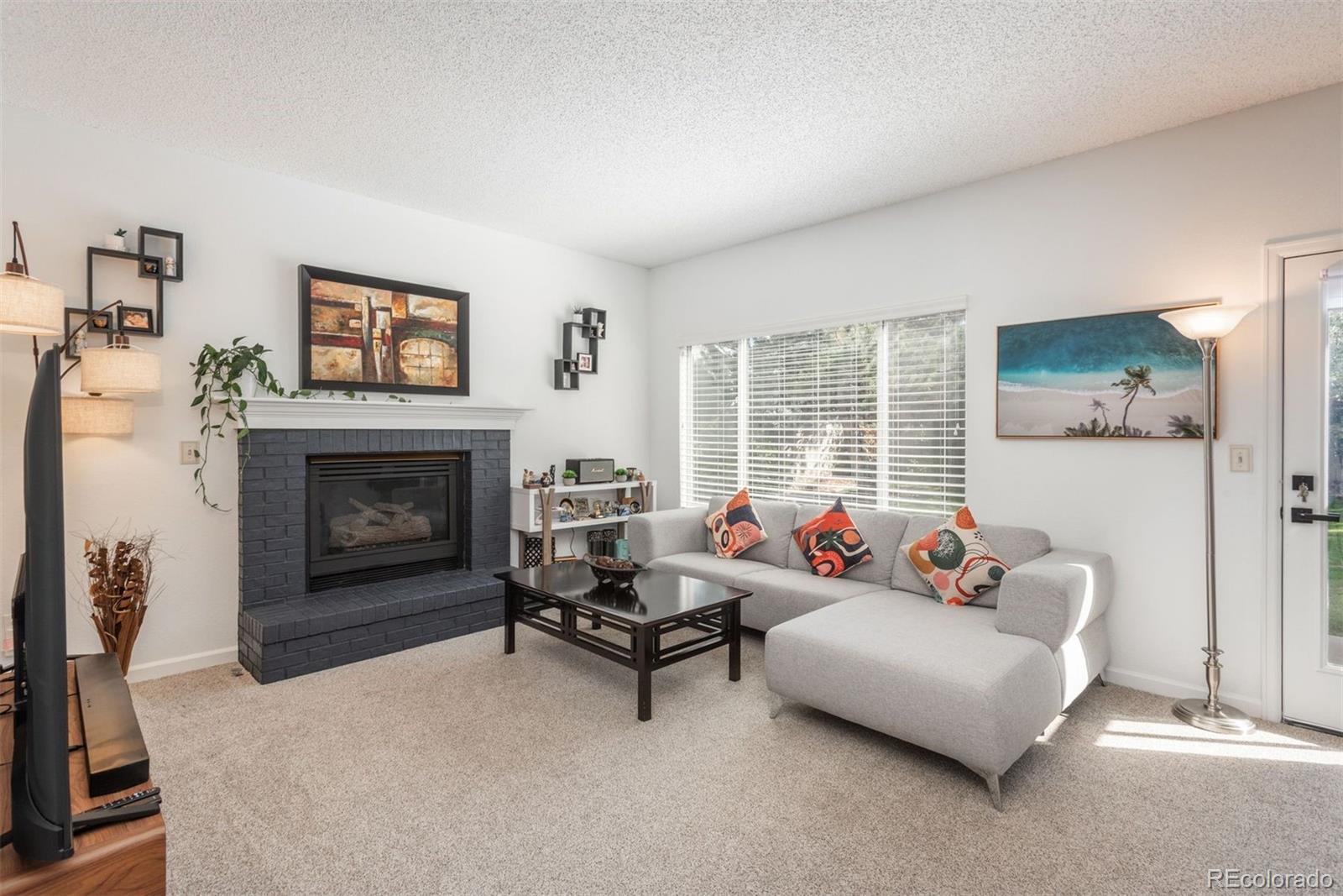 9222 Buttonhill Court Highlands Ranch, CO 80130 - Photo 15 of 44 a living room with furniture and a fireplace