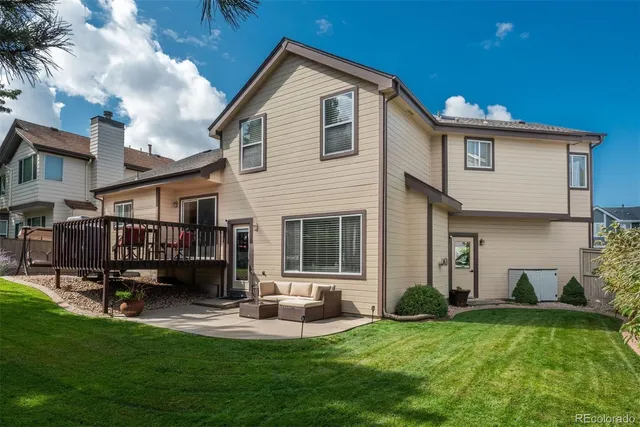 a front view of house with yard and outdoor seating