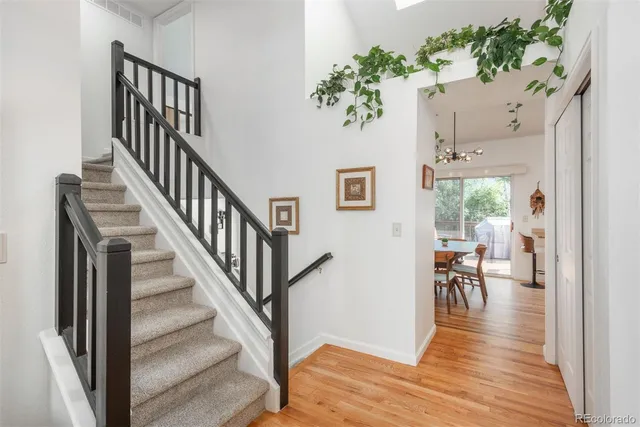 a view of a hallway with wooden floor and entryway
