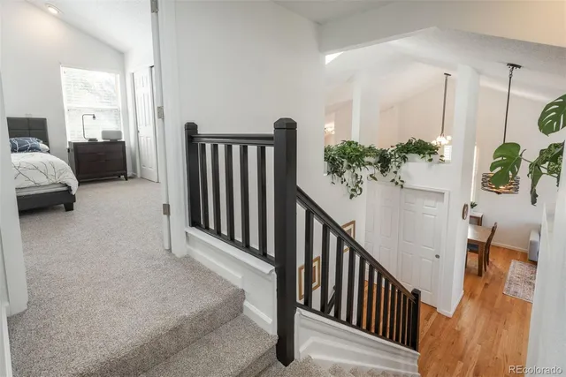 a view of a hallway to a livingroom with furniture and stairs