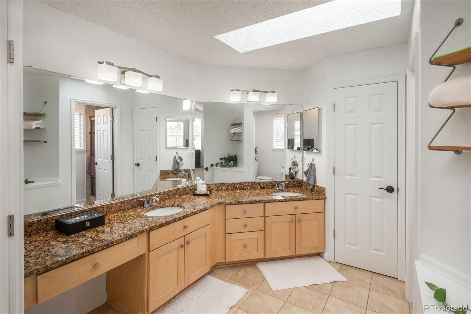 9222 Buttonhill Court Highlands Ranch, CO 80130 - Photo 27 of 44 a bathroom with a granite countertop sink double and mirror