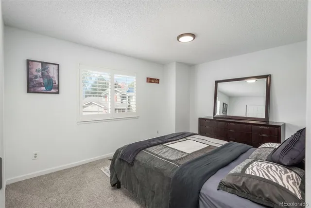 a bedroom with double bed and a window