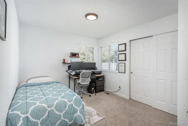 a bedroom with a workspace