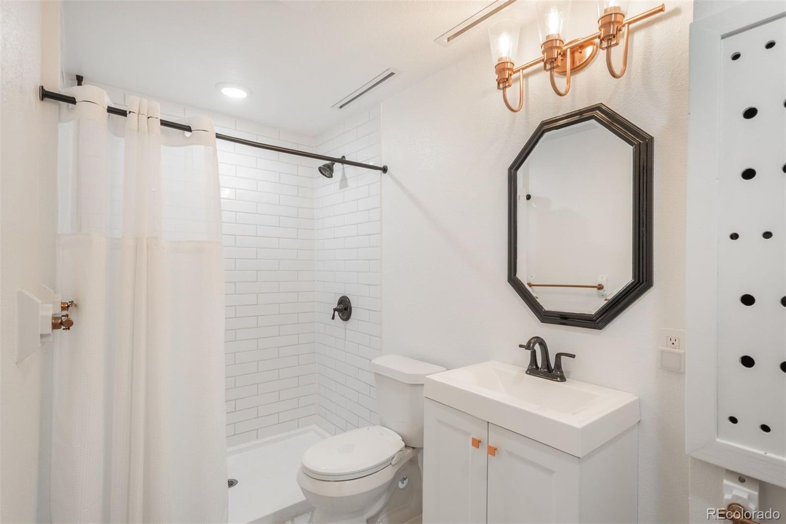 9222 Buttonhill Court Highlands Ranch, CO 80130 - Photo 35 of 44 a bathroom with a toilet sink and mirror