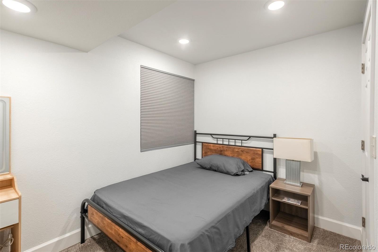 9222 Buttonhill Court Highlands Ranch, CO 80130 - Photo 36 of 44 a bedroom with a bed and a window