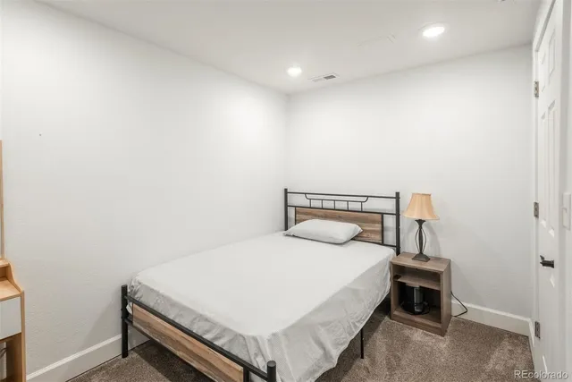 a bedroom with a bed and a night stand