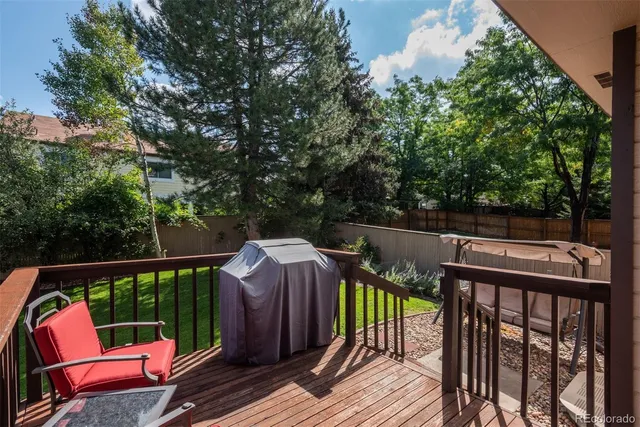a view of a deck with two chairs and a potted plant