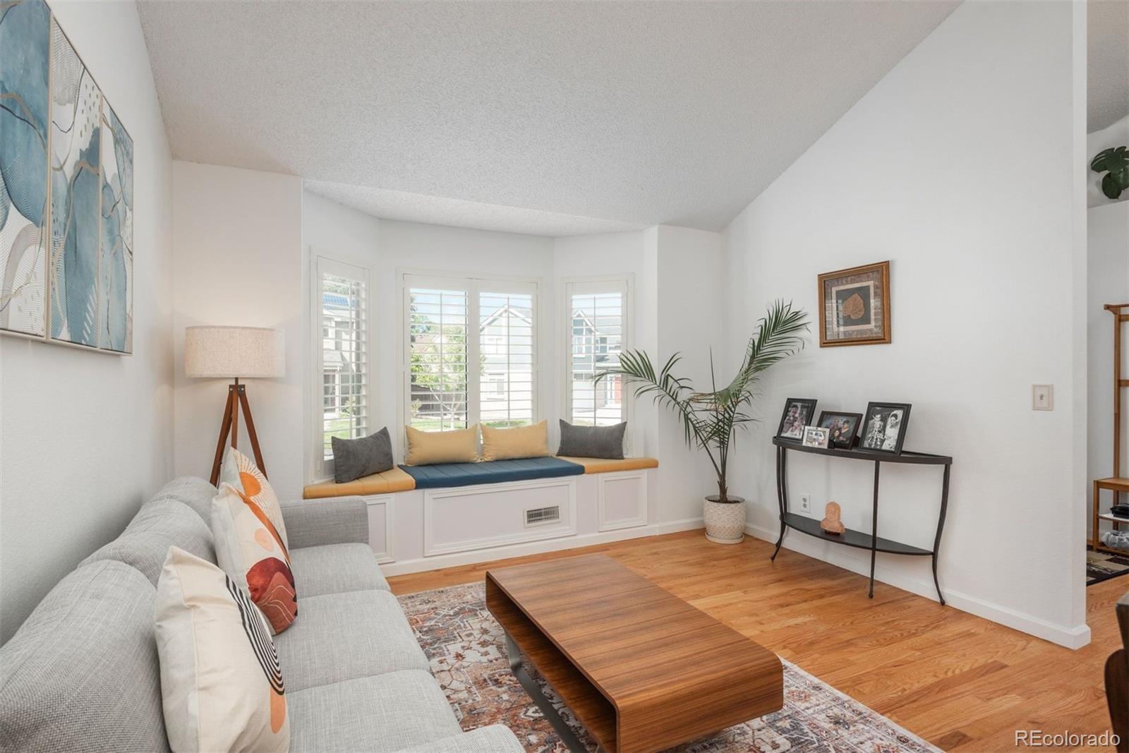 9222 Buttonhill Court Highlands Ranch, CO 80130 - Photo 6 of 44 a living room with furniture and a wooden floor
