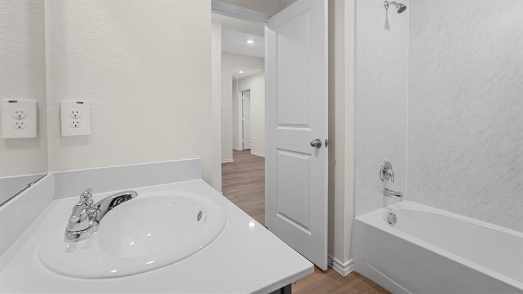 1969 Freeman Street Tyler, TX 75704 - Photo 29 of 30 Bathroom featuring a built-in vanity with an integrated sink, polished chrome faucet, and white countertop