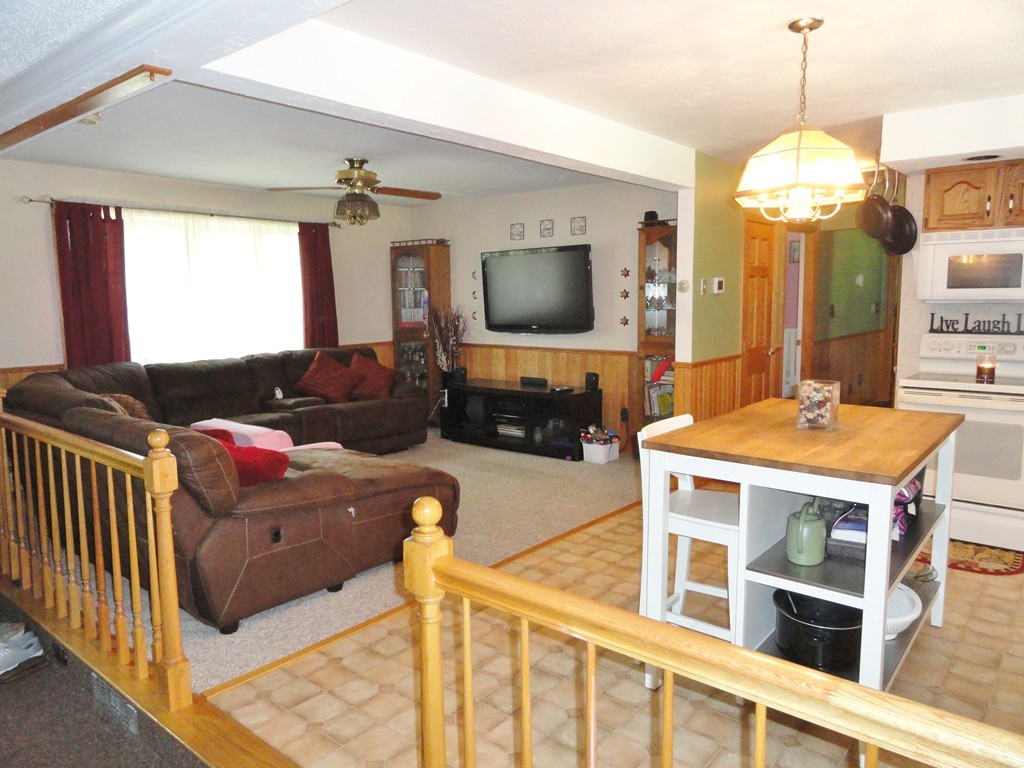 108 Knower Road Westminster, MA 01473 - Photo 12 of 25 a living room with furniture a fireplace and a flat screen tv