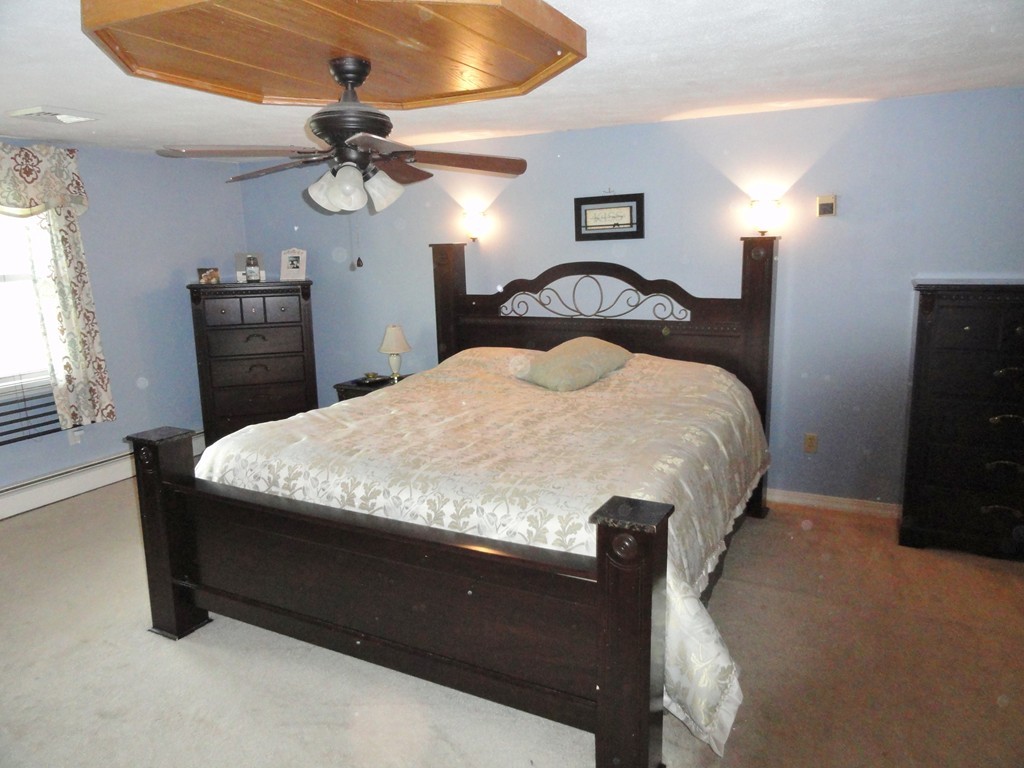 108 Knower Road Westminster, MA 01473 - Photo 17 of 25 a bedroom with a bed and a chandelier