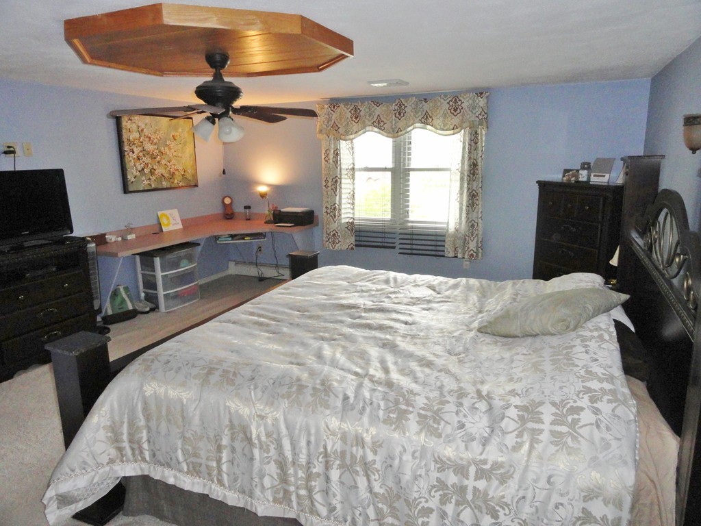 108 Knower Road Westminster, MA 01473 - Photo 18 of 25 a bedroom with a bed and a chandelier