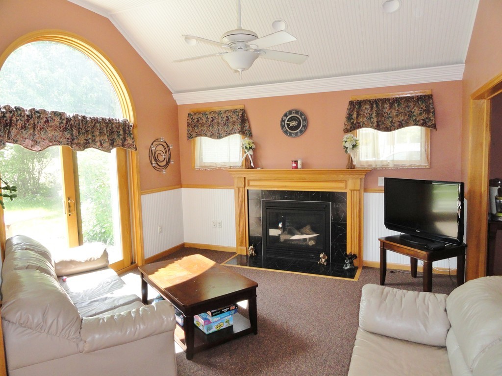 108 Knower Road Westminster, MA 01473 - Photo 7 of 25 a living room with furniture a flat screen tv and a fireplace