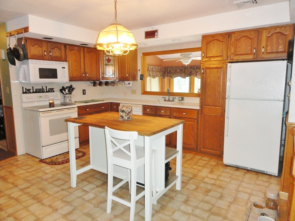 108 Knower Road Westminster, MA 01473 - Photo 10 of 25 a kitchen with a stove a sink and a refrigerator