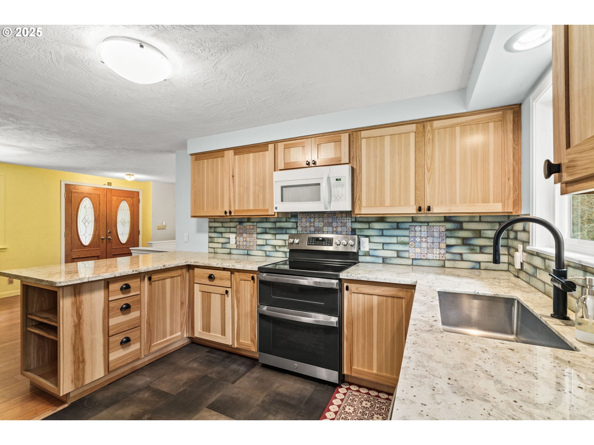 40153 Booth Kelly Road Springfield, OR 97478 - Photo 12 of 44 a kitchen with stainless steel appliances granite countertop a stove a sink dishwasher and a microwave