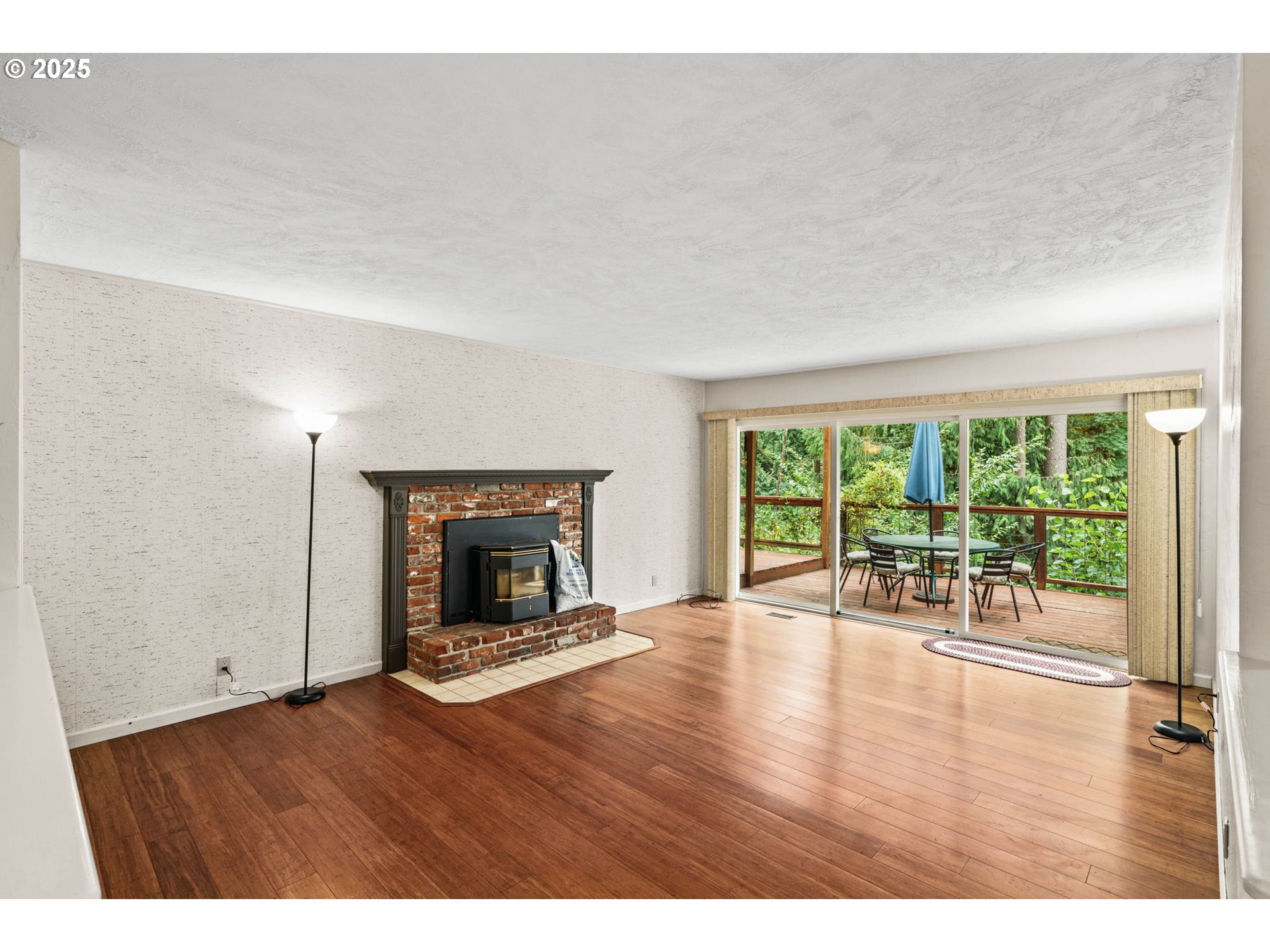 40153 Booth Kelly Road Springfield, OR 97478 - Photo 13 of 44 a view of an empty room with wooden floor and a fireplace
